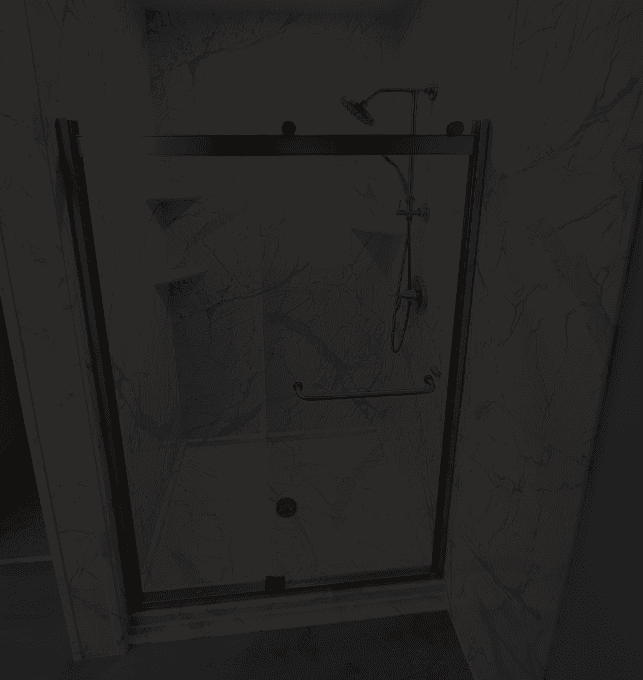A walk-in shower with sliding glass doors, corner shelves, and marbled walls.