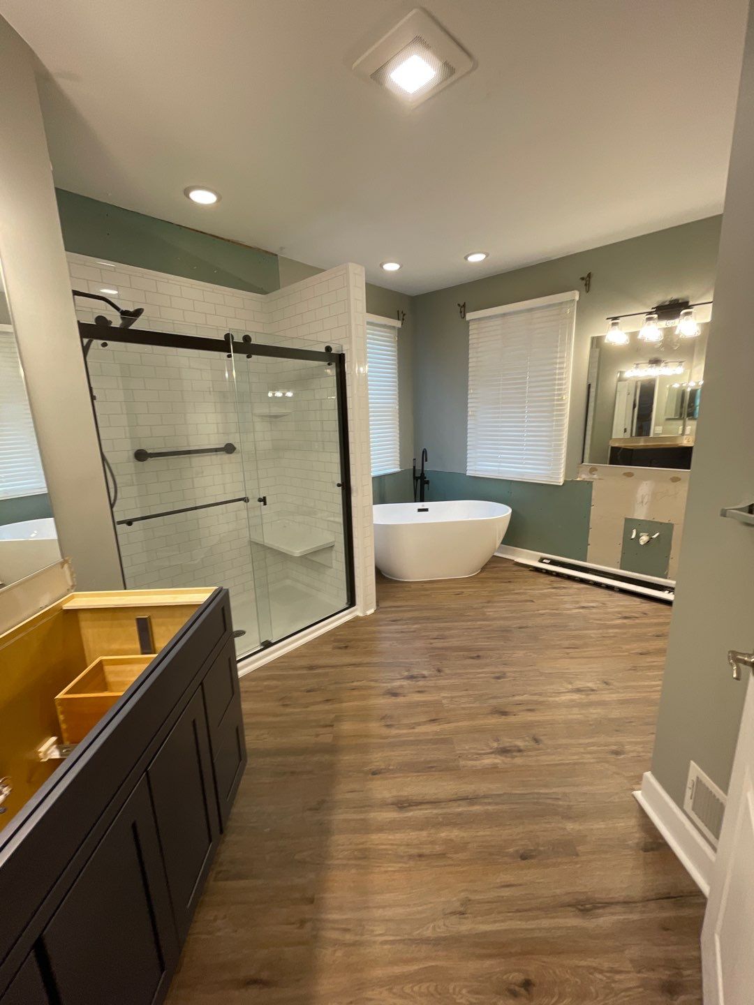 walk-in shower and freestanding tub after full bathroom remodel