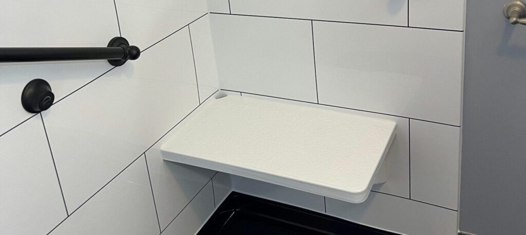 white shower bench added to a walk-in shower